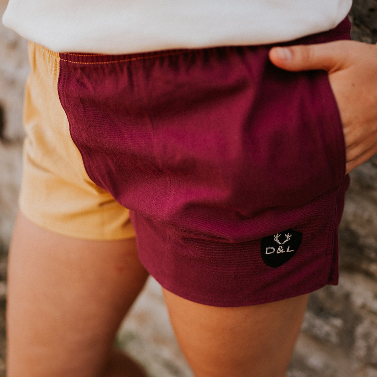 Digby & Litten Maroon & Gold Rugby Shorts — close-up detail.